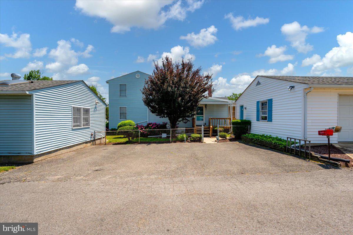 8236 Bayside Road Chesapeake Beach, MD 20732 - Photo 32 of 39 a view of a house with a patio and a yard