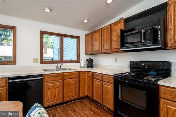 a kitchen with stainless steel appliances a stove sink microwave and cabinets