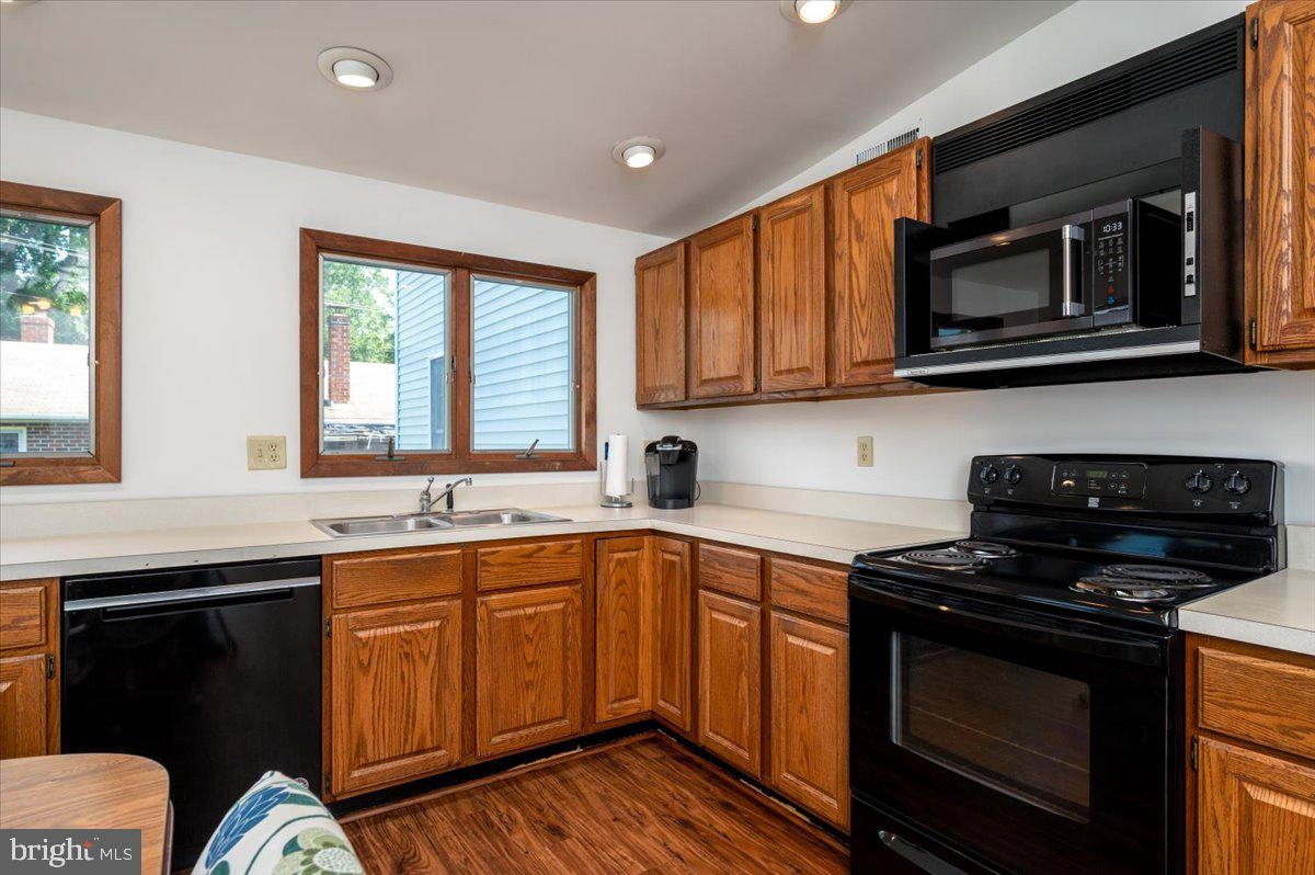 8236 Bayside Road Chesapeake Beach, MD 20732 - Photo 7 of 39 a kitchen with stainless steel appliances a stove sink microwave and cabinets