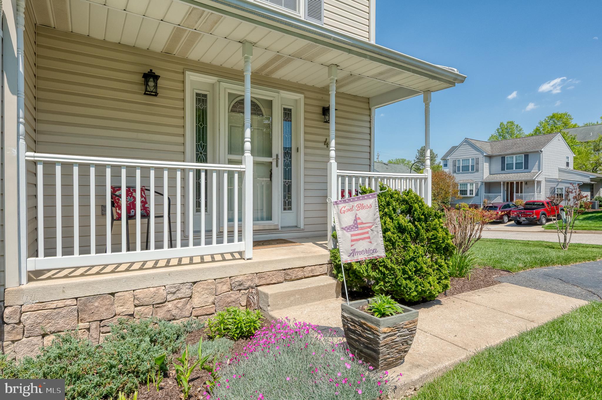 4 Kings Place Nottingham, MD 21236 - Photo 2 of 55 Charming shaded porch with vibrant blooms.