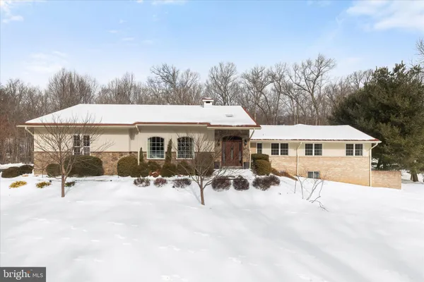 a view of a house with a yard patio and sitting area