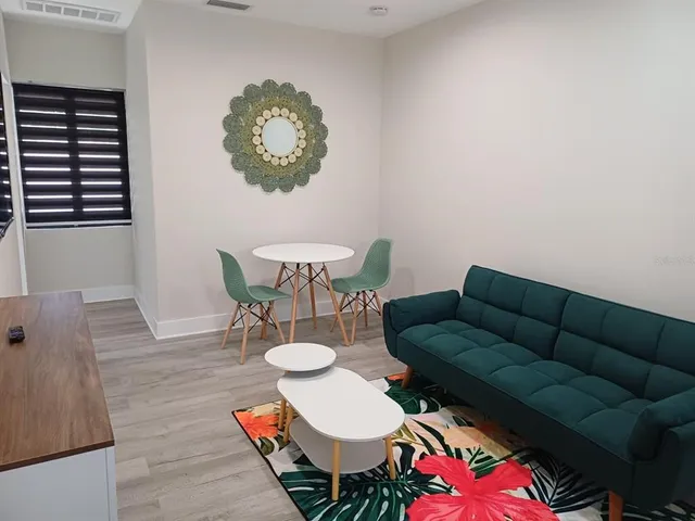 a living room with furniture a table and chair