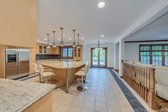 a large kitchen with a table and chairs
