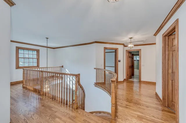 a spacious en suite bathroom with a tub and window