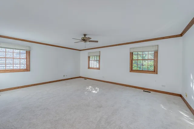 a spacious bathroom with a granite countertop sink mirror and bathtub