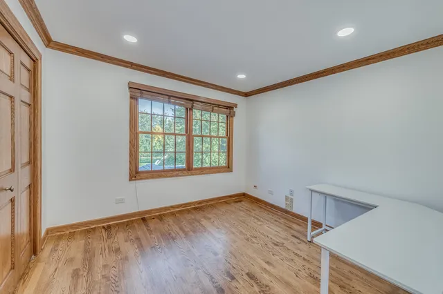 a view of a balcony with wooden floor and fence