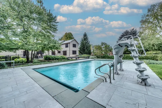 a front view of a house with a garden and plants