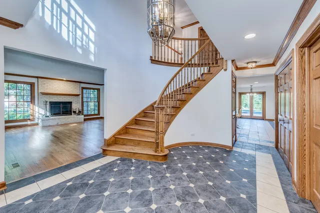 a view of empty room with wooden floor and fireplace
