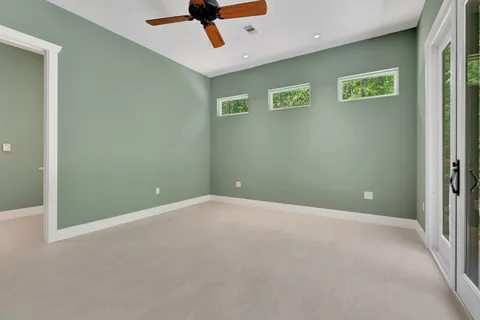 a bedroom with a bed and painting on the wall