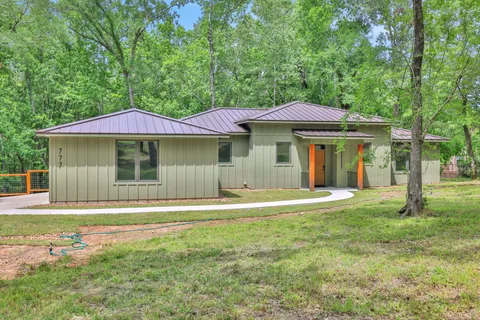 a white house with a large pool in front of it