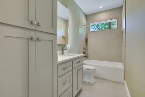 an empty room with a window and ceiling fan