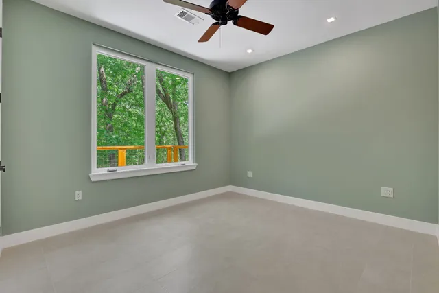 an aerial view of a tennis ground and a yard