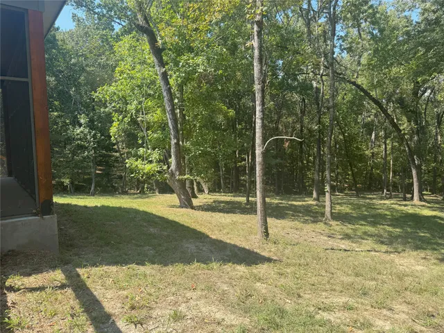 an aerial view of a tennis ground and a yard
