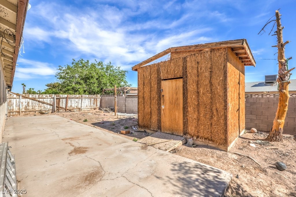 3948 Maple Hill Road Las Vegas, NV 89115 - Photo 19 of 20 View of shed featuring a fenced backyard and central AC