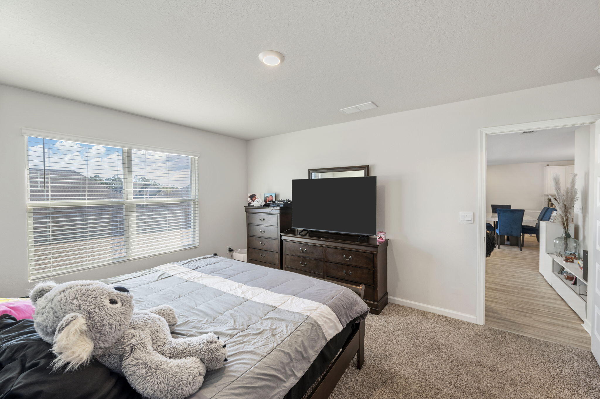 4735 Airmen Drive Crestview, FL 32539 - Photo 12 of 29 a bedroom with a bed and flat tv screen on the dresser