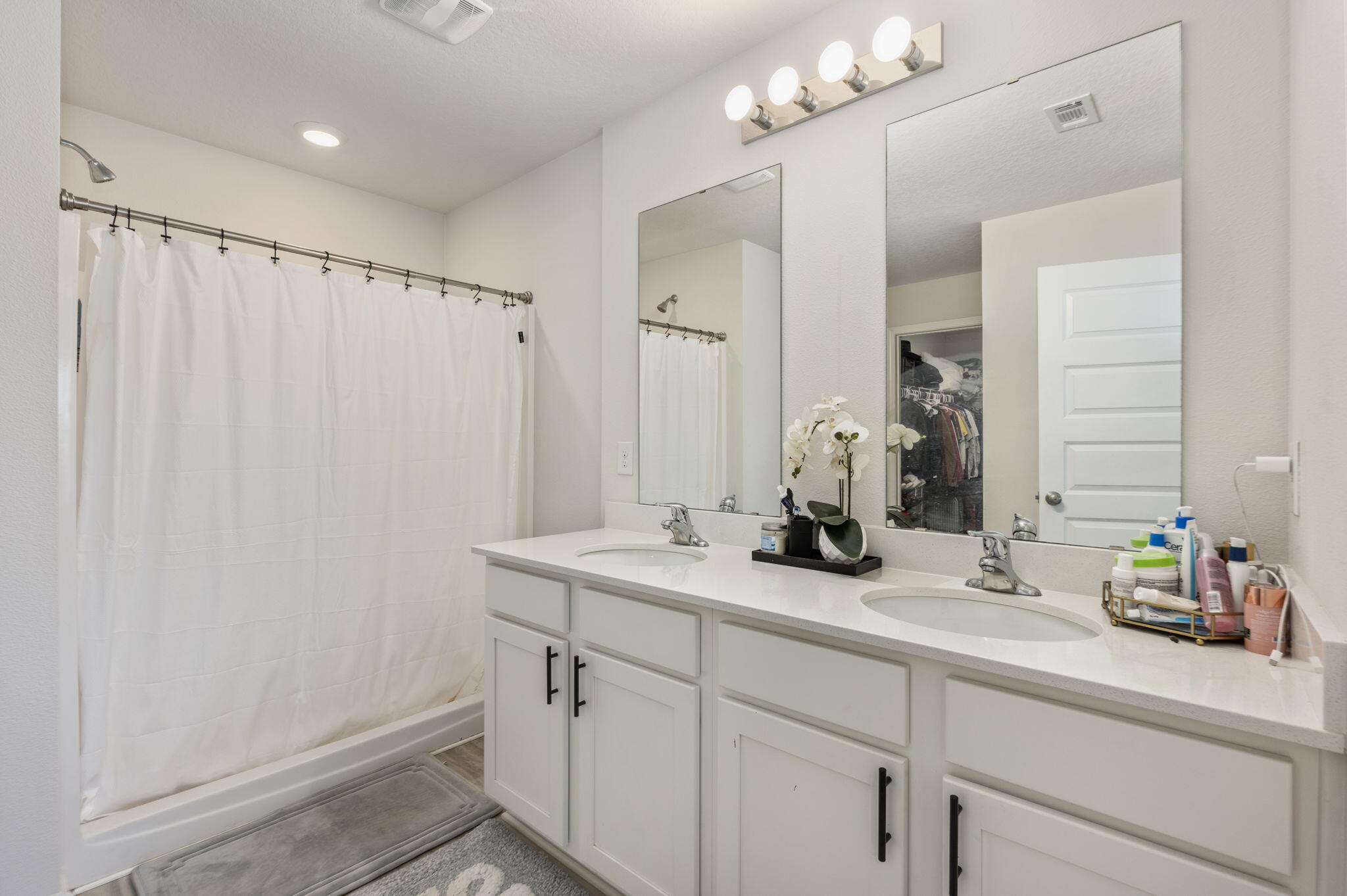 4735 Airmen Drive Crestview, FL 32539 - Photo 13 of 29 a bathroom with a sink and mirror with shower