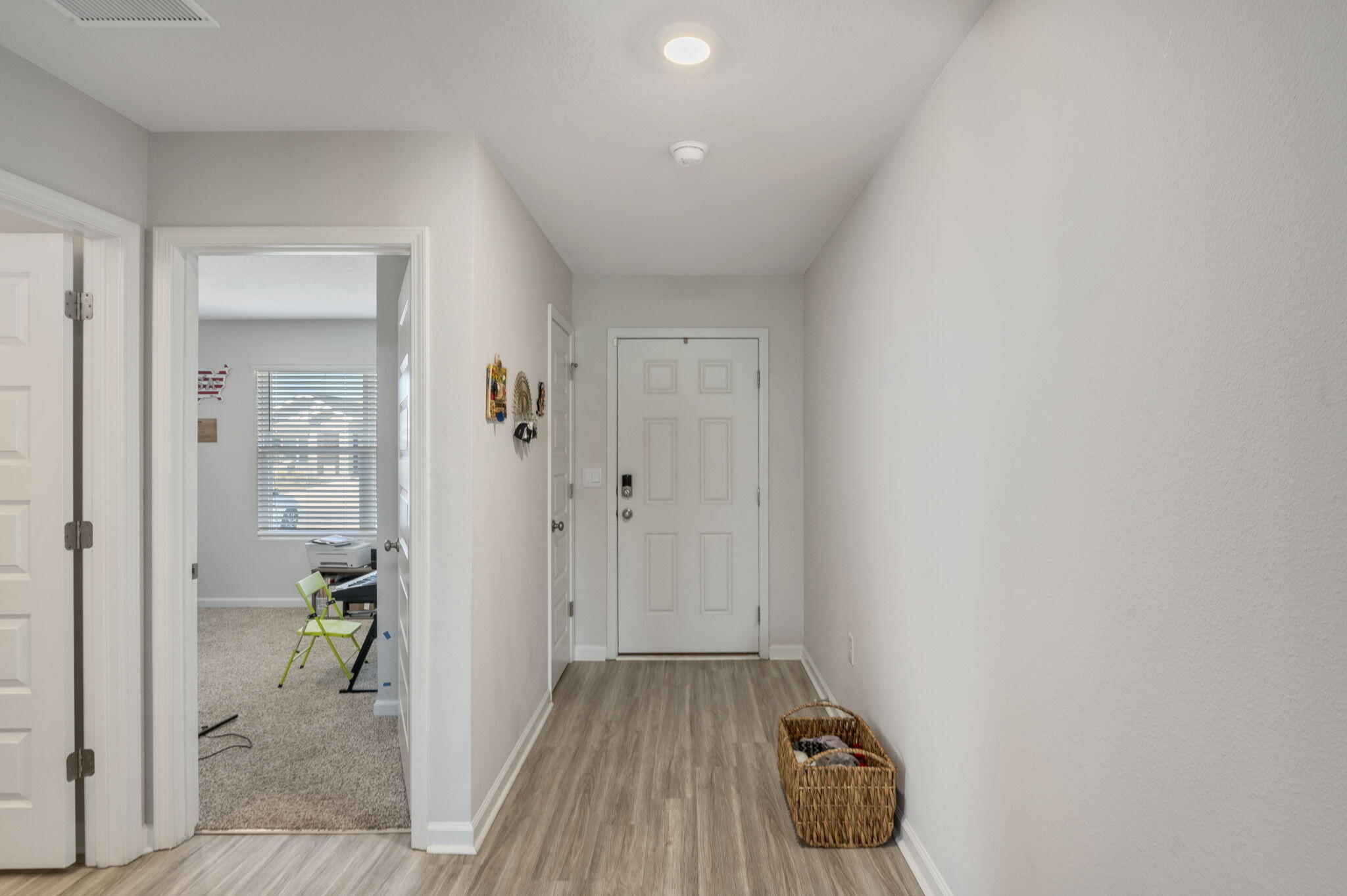 4735 Airmen Drive Crestview, FL 32539 - Photo 17 of 29 a hallway with sliding door and wooden floor