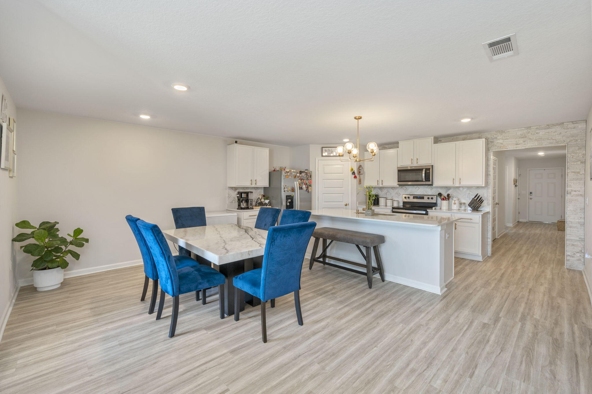 4735 Airmen Drive Crestview, FL 32539 - Photo 2 of 29 a view of a dining room with furniture and wooden floor