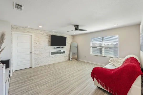 a view of a livingroom with furniture and a flat screen tv