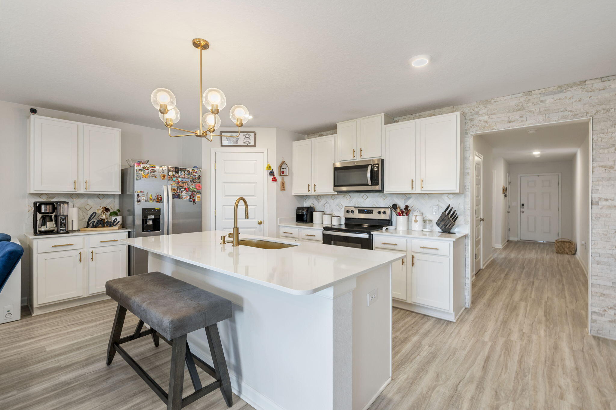 4735 Airmen Drive Crestview, FL 32539 - Photo 4 of 29 a large kitchen with white cabinets stainless steel appliances and dining table