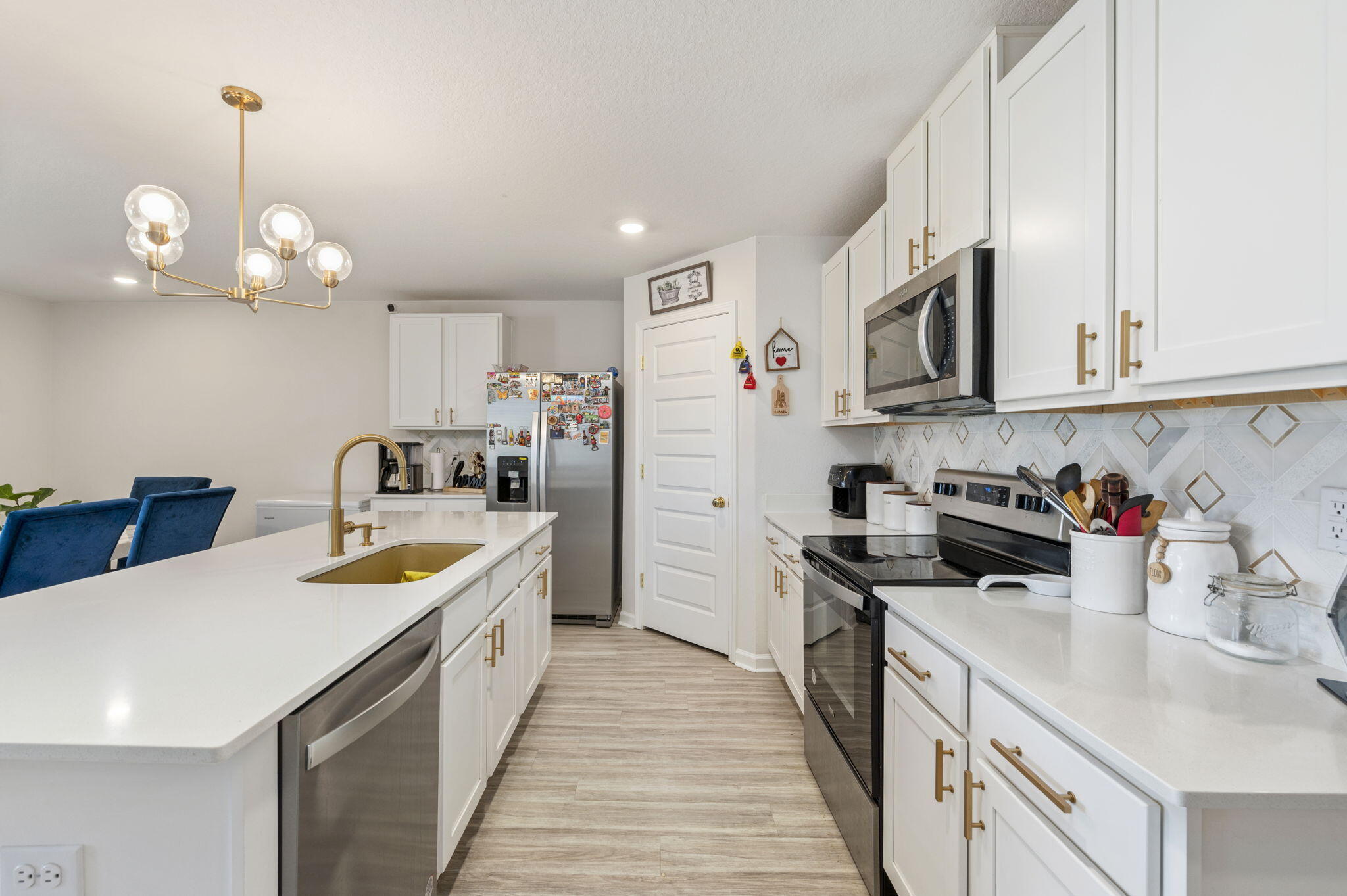 4735 Airmen Drive Crestview, FL 32539 - Photo 5 of 29 a kitchen with kitchen island granite countertop stainless steel appliances a sink a stove and cabinets