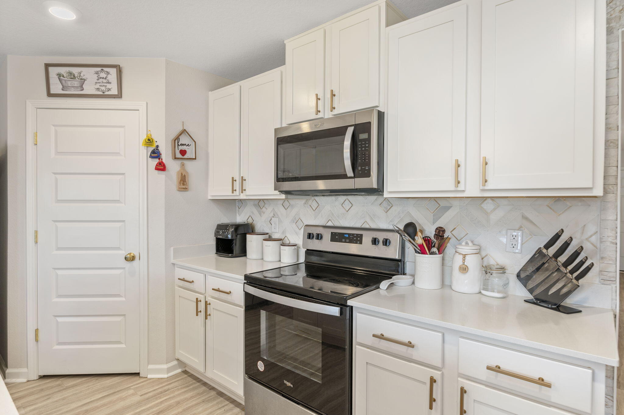 4735 Airmen Drive Crestview, FL 32539 - Photo 6 of 29 a kitchen with stainless steel appliances granite countertop a stove a microwave and cabinets