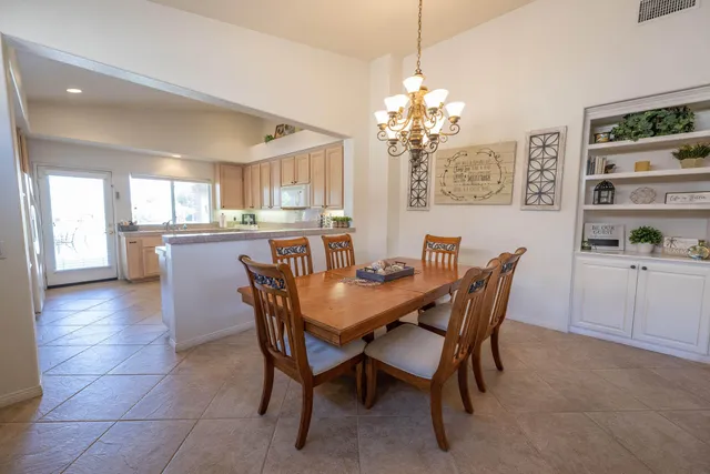 a view of a dining room with furniture and chandelier