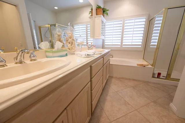 a spacious bathroom with a bathtub sink and a mirror