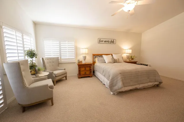 a bedroom with bed couch and window