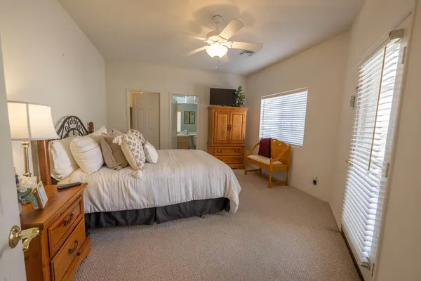 a bedroom with bed and a chandelier