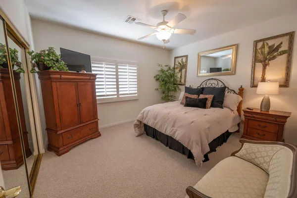 a bedroom with a large bed and a chandelier