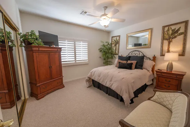 a bedroom with a large bed and a chandelier