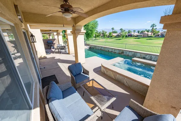 a view of a patio with couches chairs and a fire pit