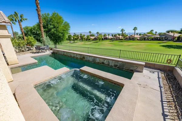 a view of a swimming pool and a yard
