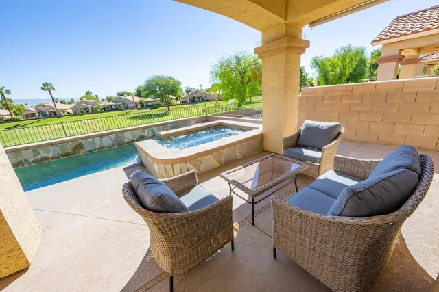a view of a chairs and table in the patio