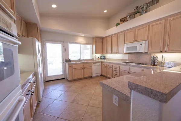 a kitchen with a sink window and cabinets