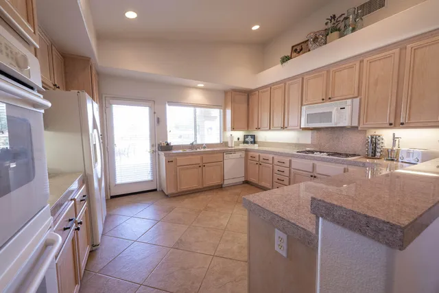 a kitchen with a sink window and cabinets