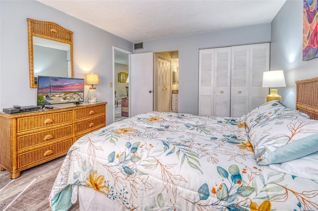 13714 Mission Oaks Boulevard, Unit 13714 Seminole, FL 33776 - Photo 12 of 24 a bedroom with a bed and a dresser in it