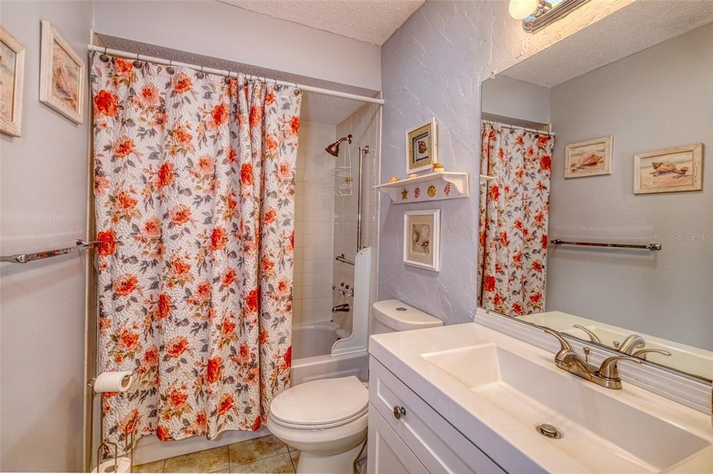 13714 Mission Oaks Boulevard, Unit 13714 Seminole, FL 33776 - Photo 18 of 24 a bathroom with a sink toilet and shower