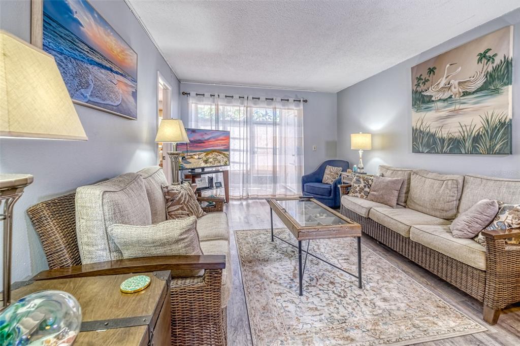 13714 Mission Oaks Boulevard, Unit 13714 Seminole, FL 33776 - Photo 2 of 24 a living room with furniture and wooden floor