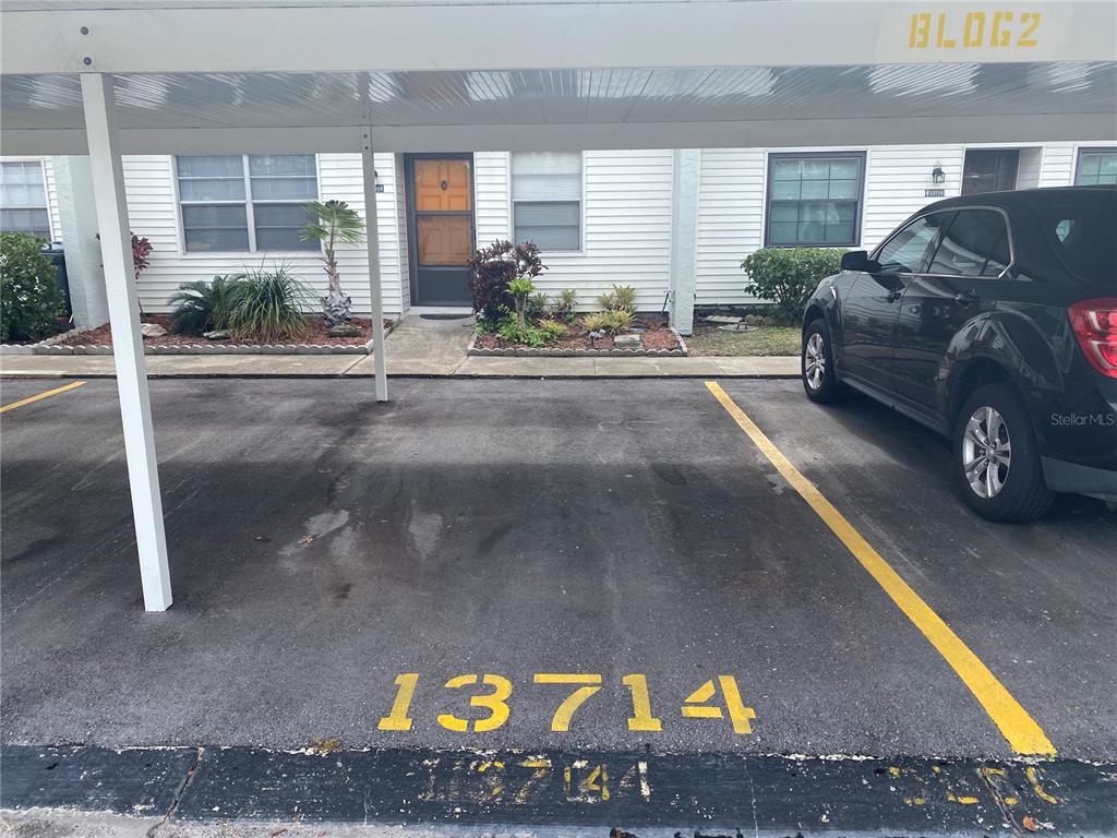 13714 Mission Oaks Boulevard, Unit 13714 Seminole, FL 33776 - Photo 22 of 24 a car parked in front of a house