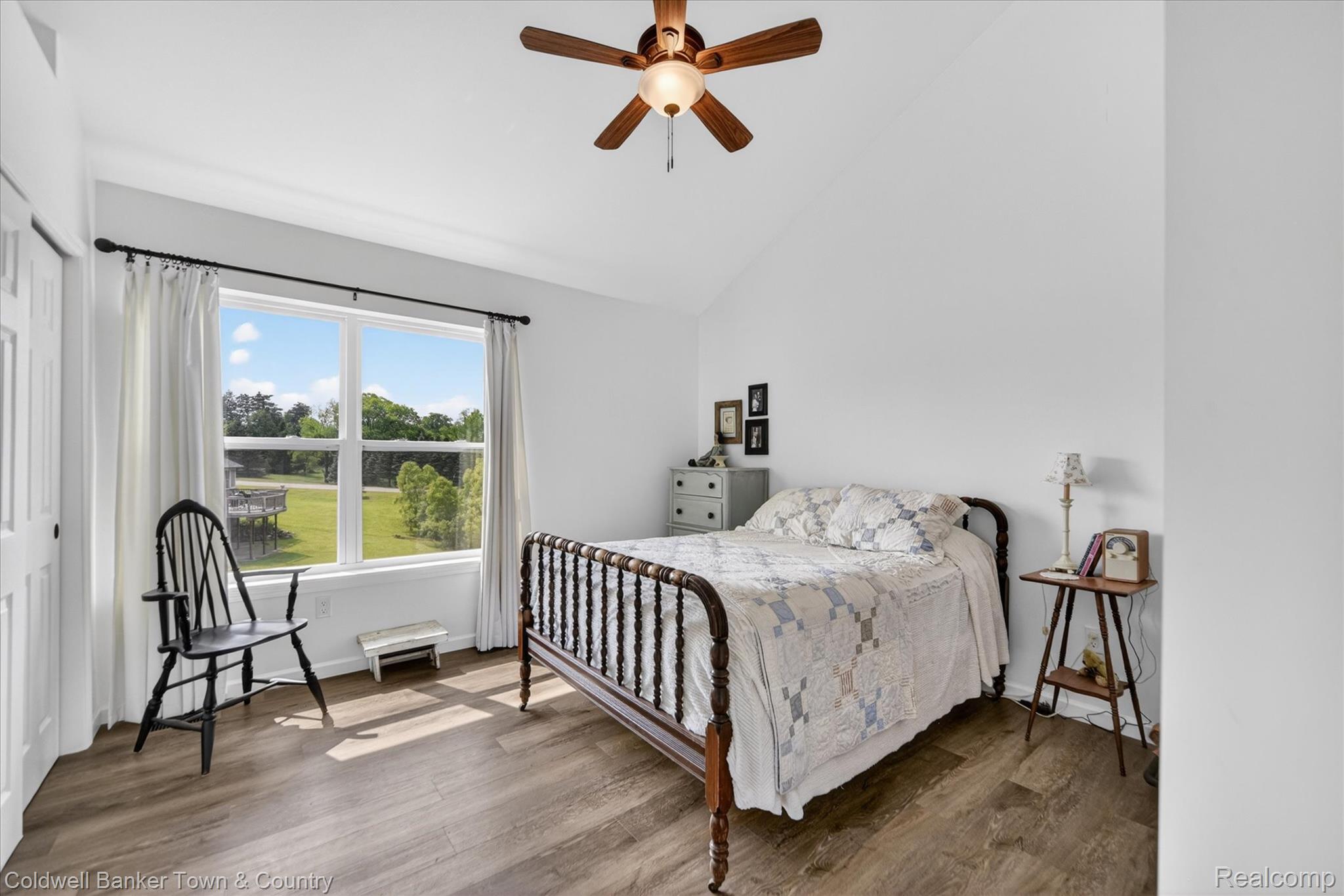 918 Gray Fox Court Howell, MI 48843 - Photo 57 of 84 Spacious room featuring vaulted ceilings, wood-finish flooring, a large window, a ceiling fan with integrated lighting, and a closet with bifold doors