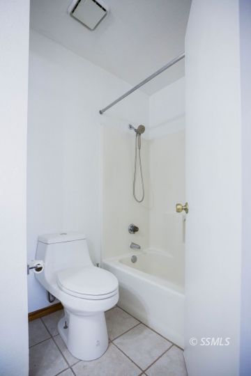 207 East Upjohn Avenue Ridgecrest, CA 93555 - Photo 16 of 20 a white toilet sitting next to a bath tub