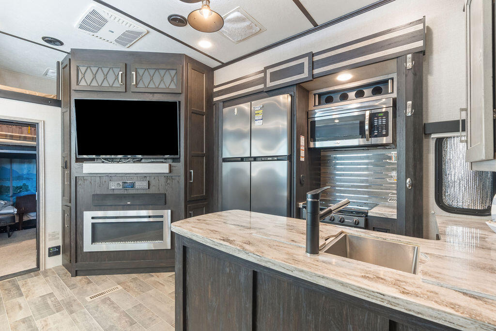 325 Calusa Street, Unit 351 Key Largo, FL 33037 - Photo 13 of 18 a kitchen with granite countertop a oven and a refrigerator