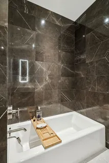 a living room with furniture floor to ceiling window and wooden floor