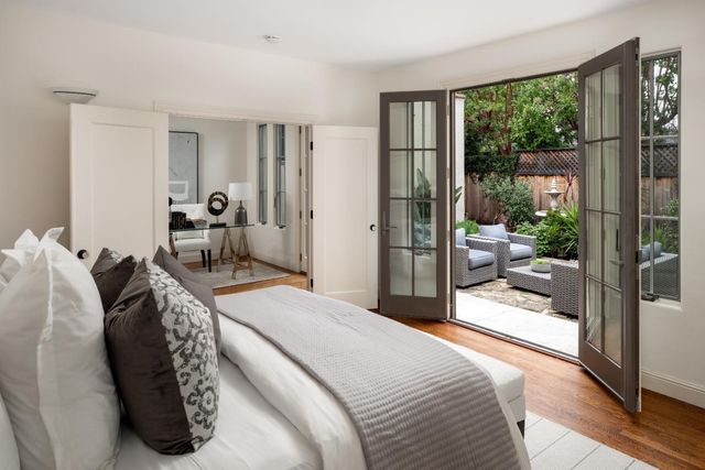 a bedroom with a large bed and a balcony view