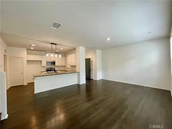 a large kitchen with a large counter top appliances and cabinets