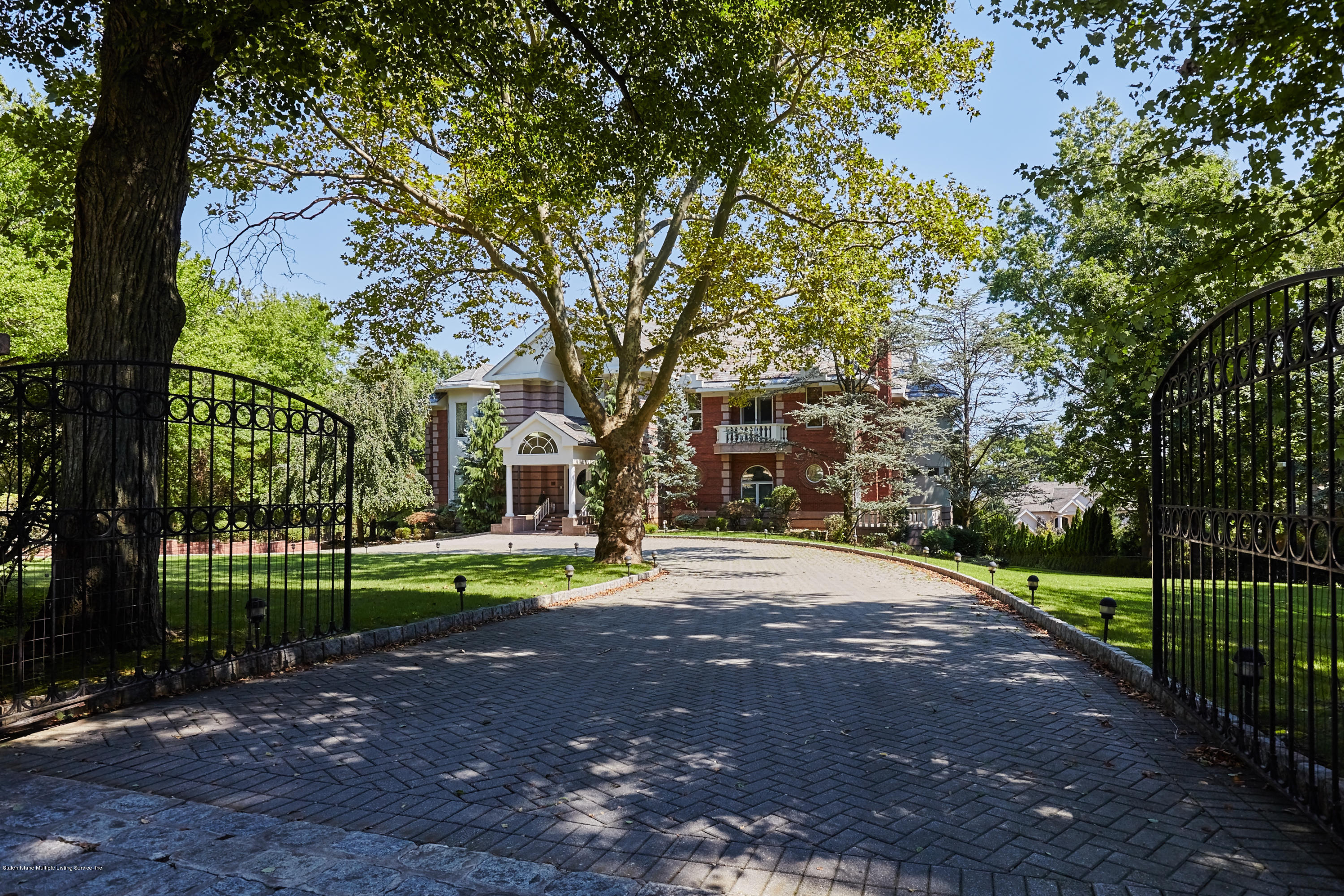a view of a street with a large trees