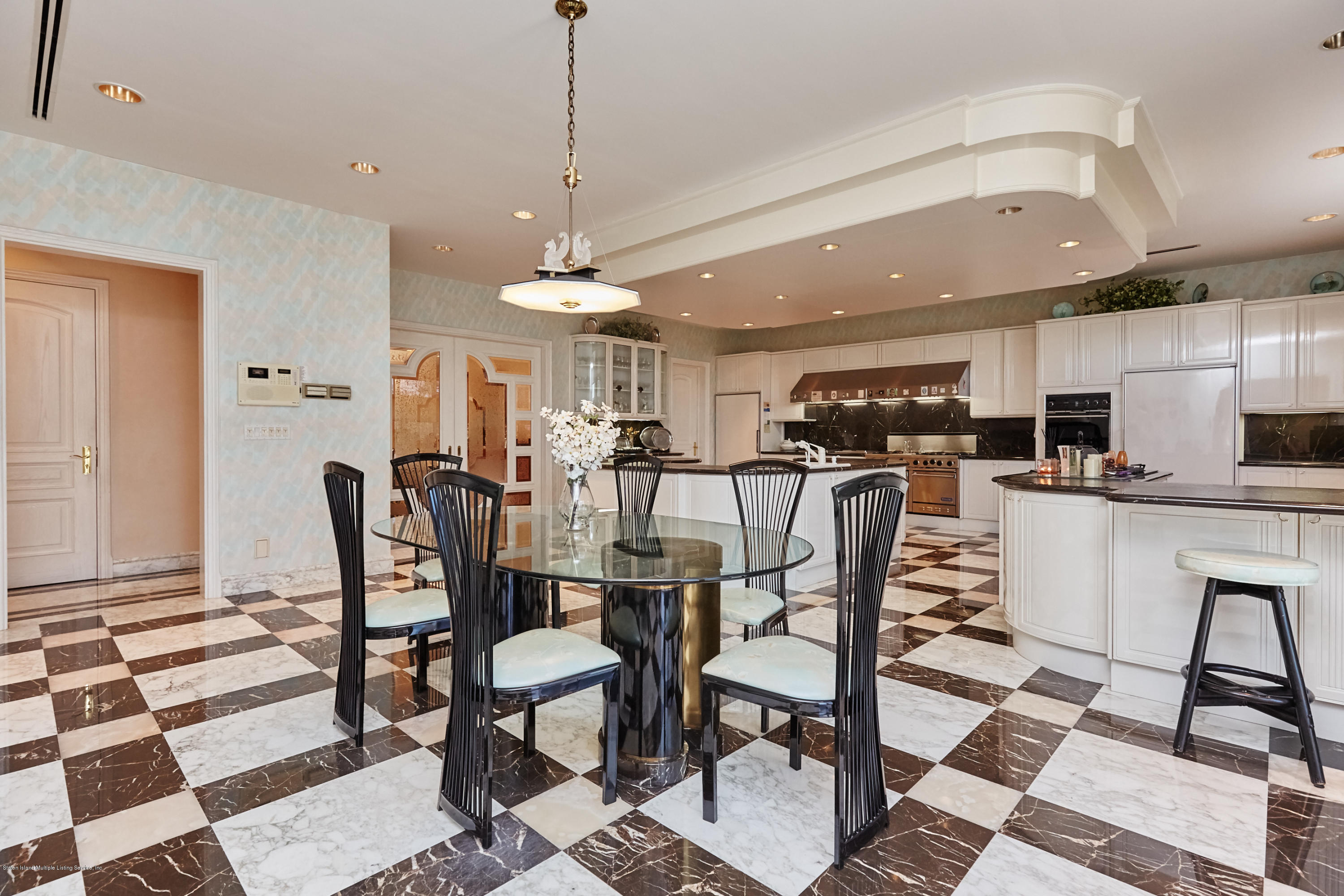 95 Circle Road Staten Island, NY 10304 - Photo 17 of 42 a dining room with stainless steel appliances kitchen island granite countertop a dining table chairs and a refrigerator