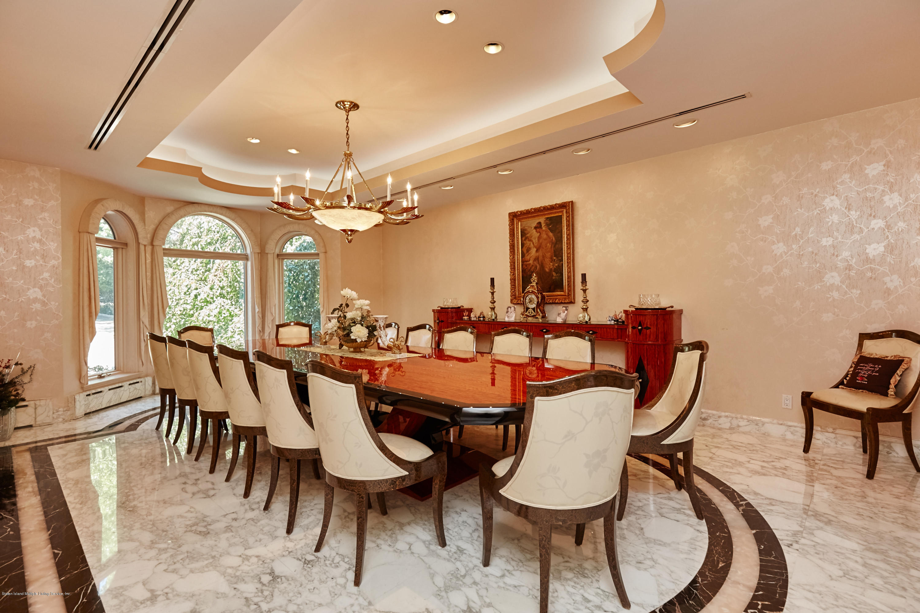 95 Circle Road Staten Island, NY 10304 - Photo 19 of 42 a dining room with furniture a chandelier and wooden floor